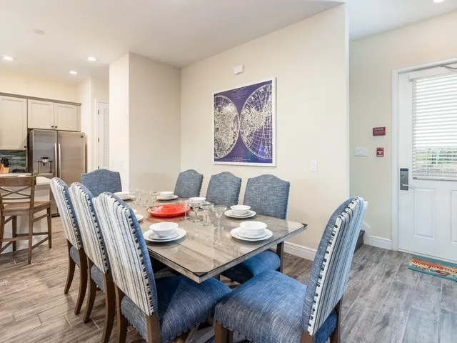 a large bed sitting in a bedroom and kitchen view