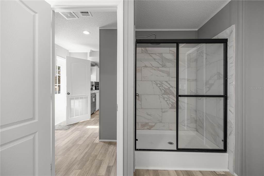 1550 Northeast 162nd Street Citra, FL 32113 - Photo 19 of 33 a view of a bathroom with a glass door