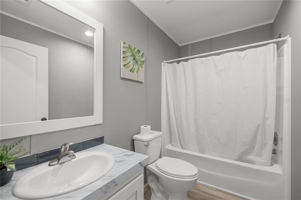 1550 Northeast 162nd Street Citra, FL 32113 - Photo 23 of 33 a bathroom with a sink toilet and shower