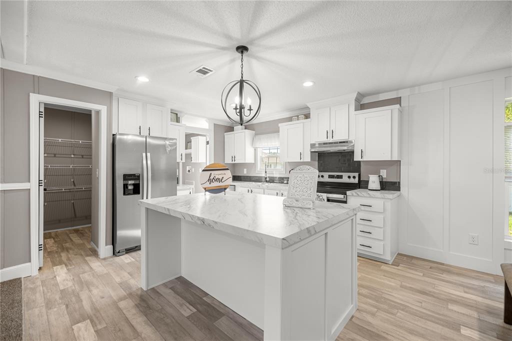 1550 Northeast 162nd Street Citra, FL 32113 - Photo 8 of 33 a kitchen with stainless steel appliances granite countertop a sink a stove a refrigerator and white cabinets