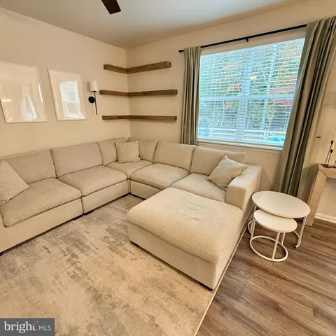 a large kitchen with a table chairs and flat screen tv
