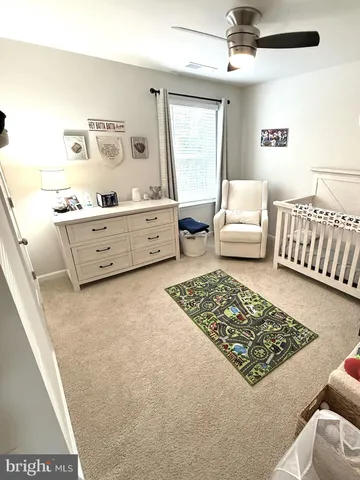 a bedroom with a bed next to a large window