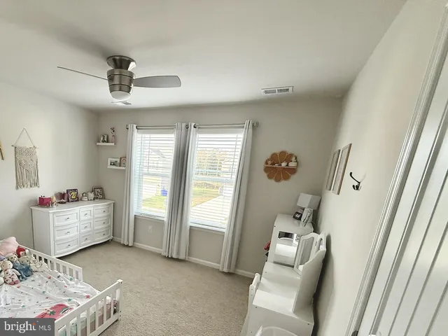 a bedroom with bed and a window