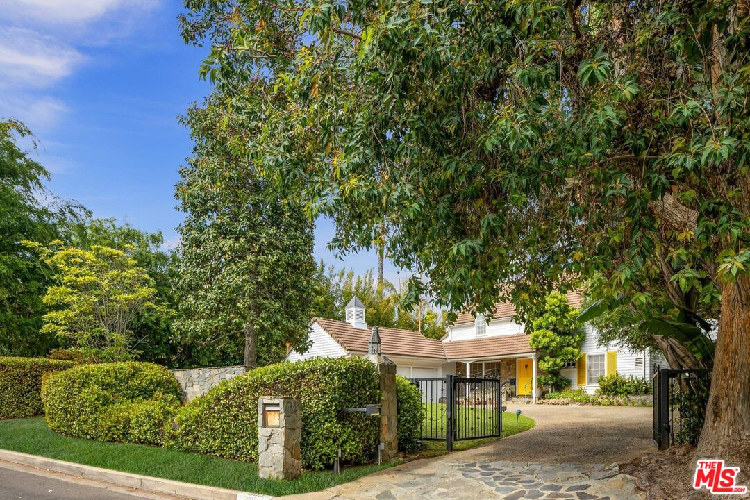 506 North Carmelina Avenue Los Angeles, CA 90049 - Photo 1 of 13 a view of a house with a tree in the background