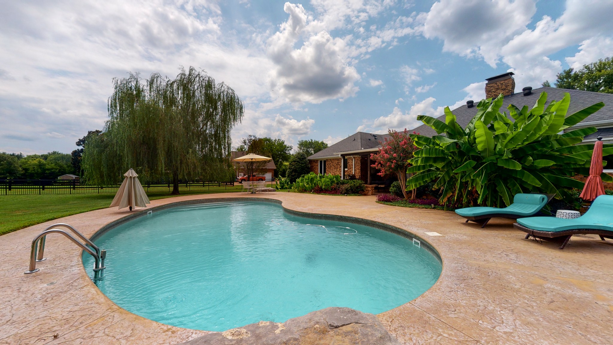 207 Bethlehem Road Lebanon, TN 37087 - Photo 29 of 35 a view of a swimming pool with a yard and plants