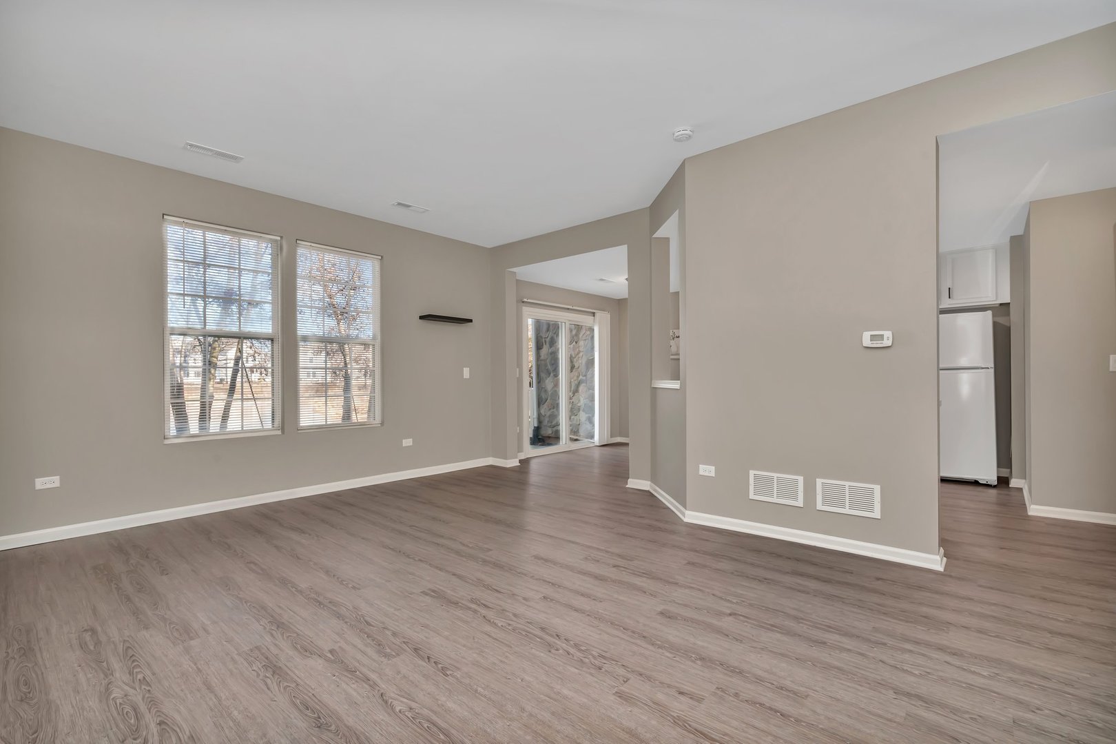 15340 Pinewood Road Lockport, IL 60441 - Photo 6 of 31 a view of an empty room with window and wooden floor