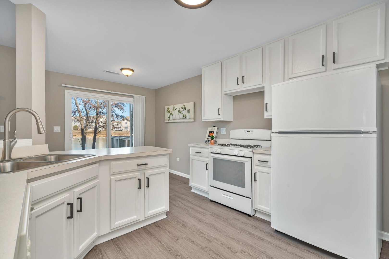 15340 Pinewood Road Lockport, IL 60441 - Photo 7 of 31 a kitchen with white cabinets and white appliances