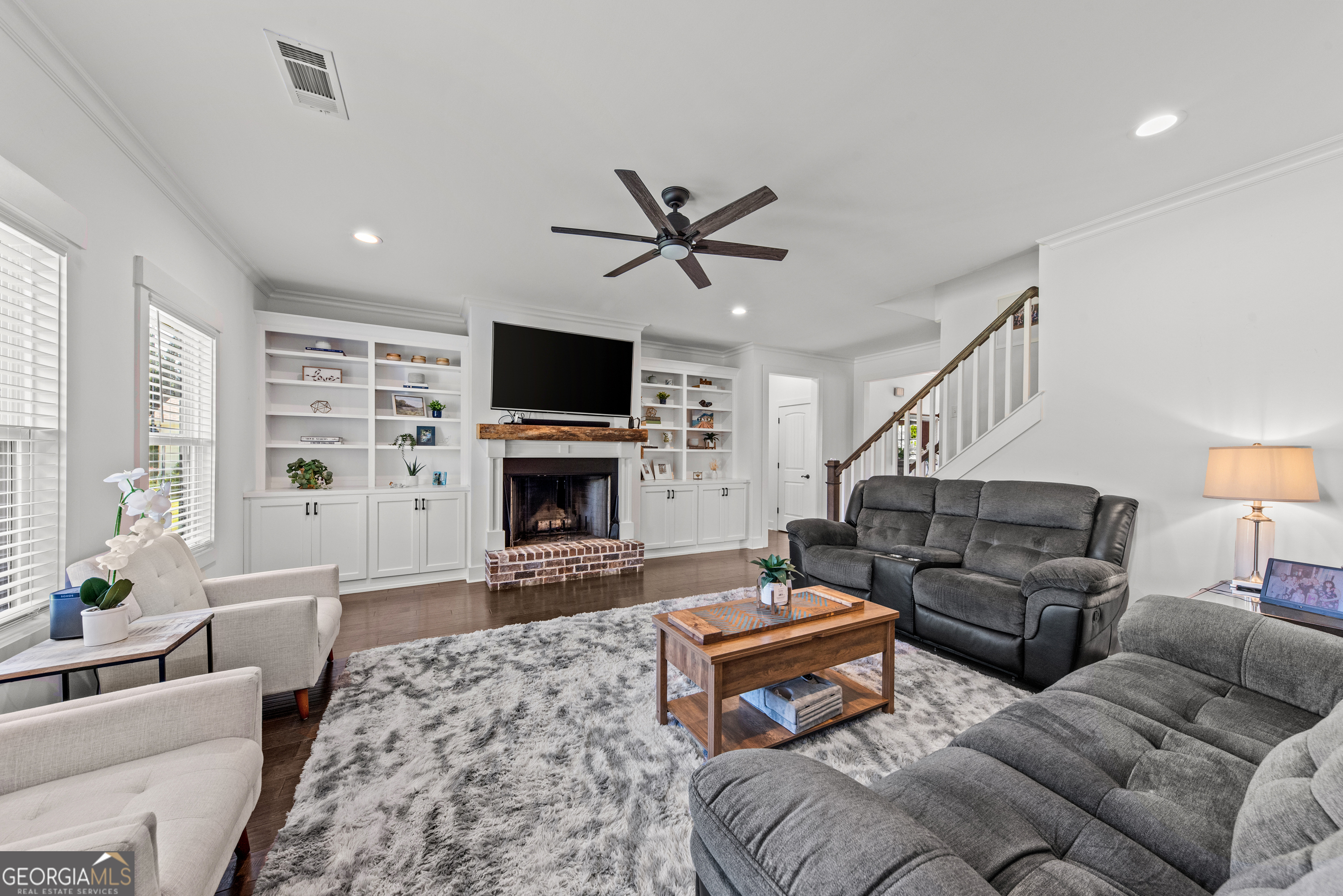 1100 West Magnolia Loop Madison, GA 30650 - Photo 11 of 40 a living room with furniture a flat screen tv and a fireplace