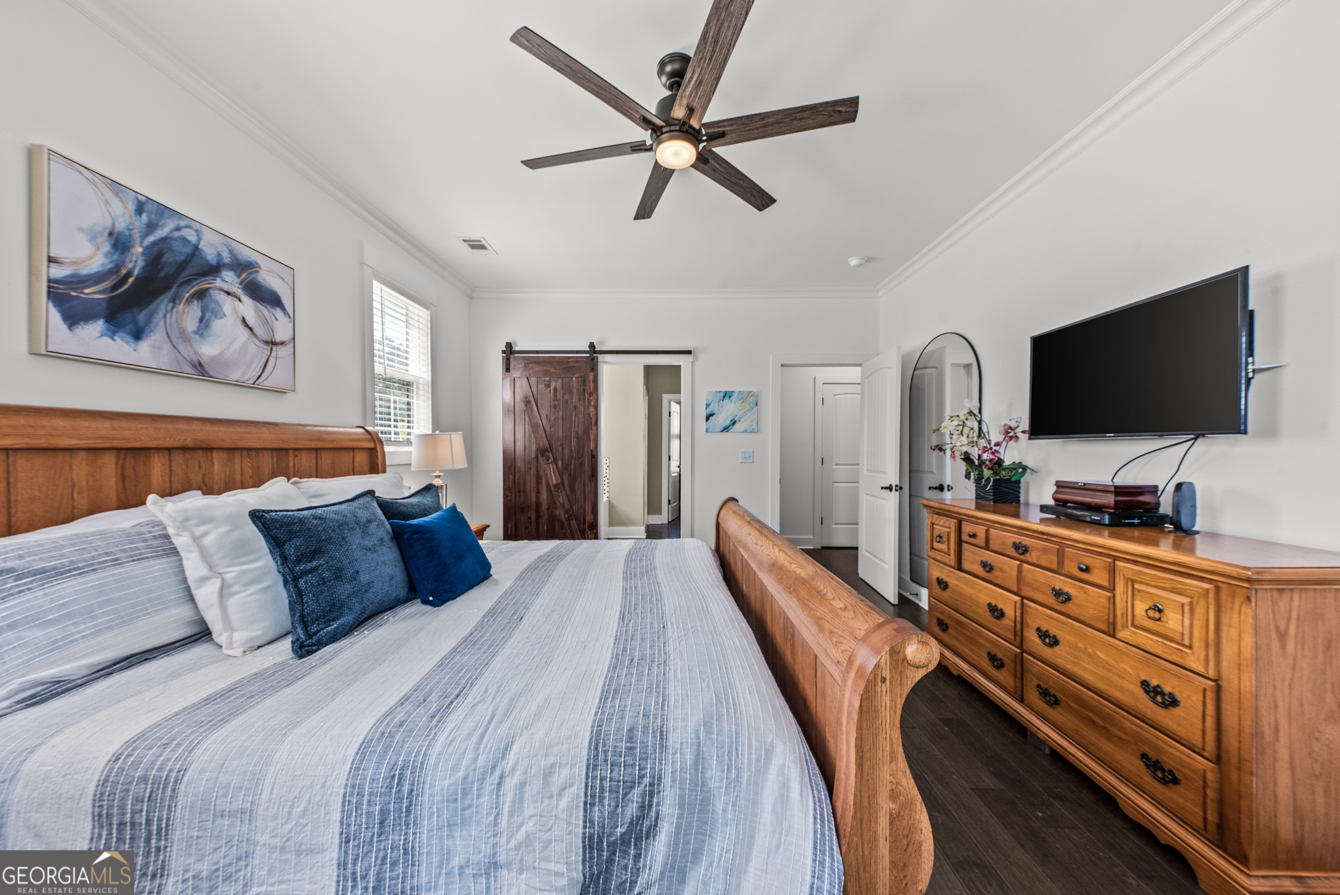 1100 West Magnolia Loop Madison, GA 30650 - Photo 19 of 40 a bedroom with furniture and flat screen tv