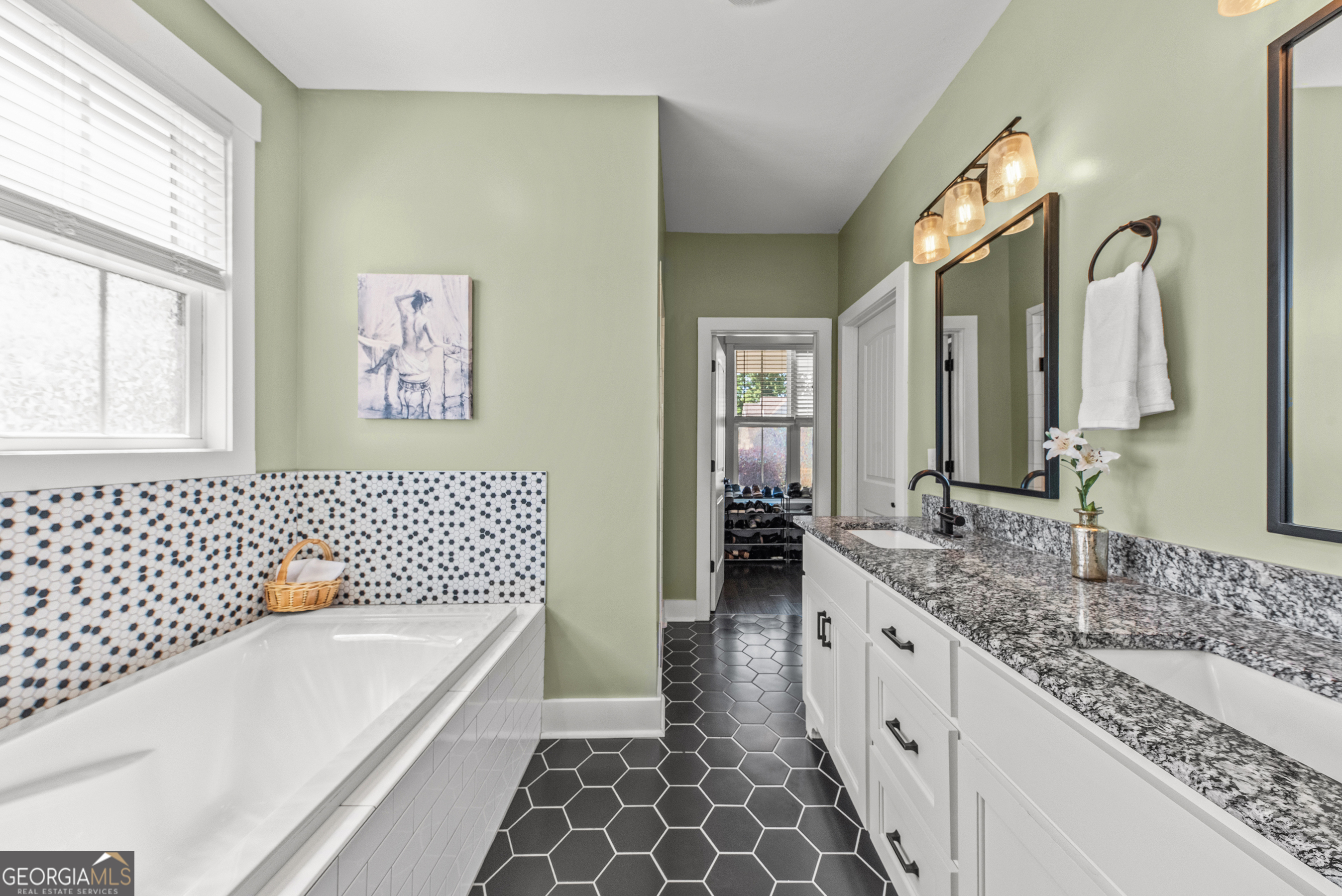 1100 West Magnolia Loop Madison, GA 30650 - Photo 21 of 40 a bathroom with a double vanity sink mirror and bathtub