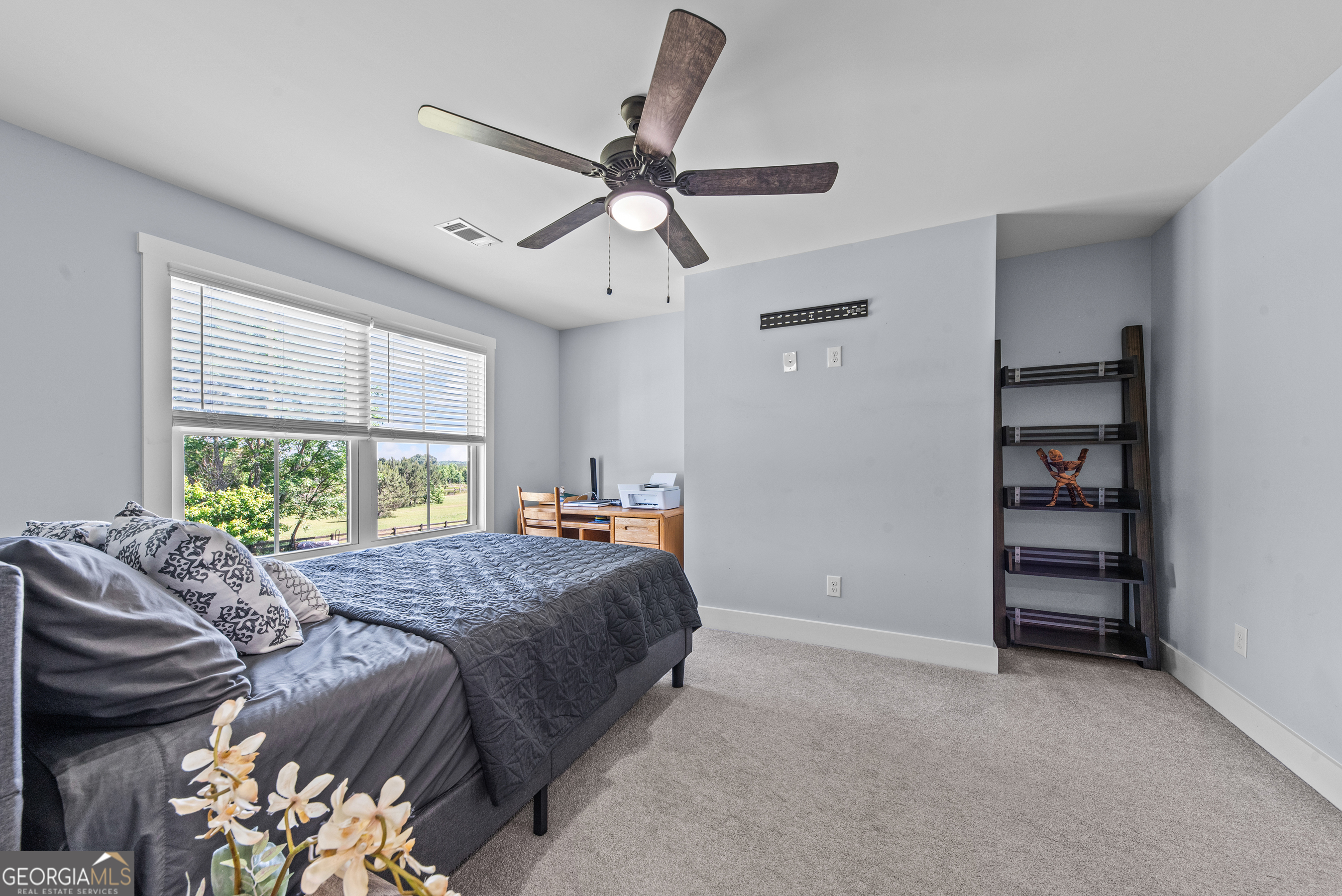 1100 West Magnolia Loop Madison, GA 30650 - Photo 25 of 40 a bed sitting in a bedroom next to a window
