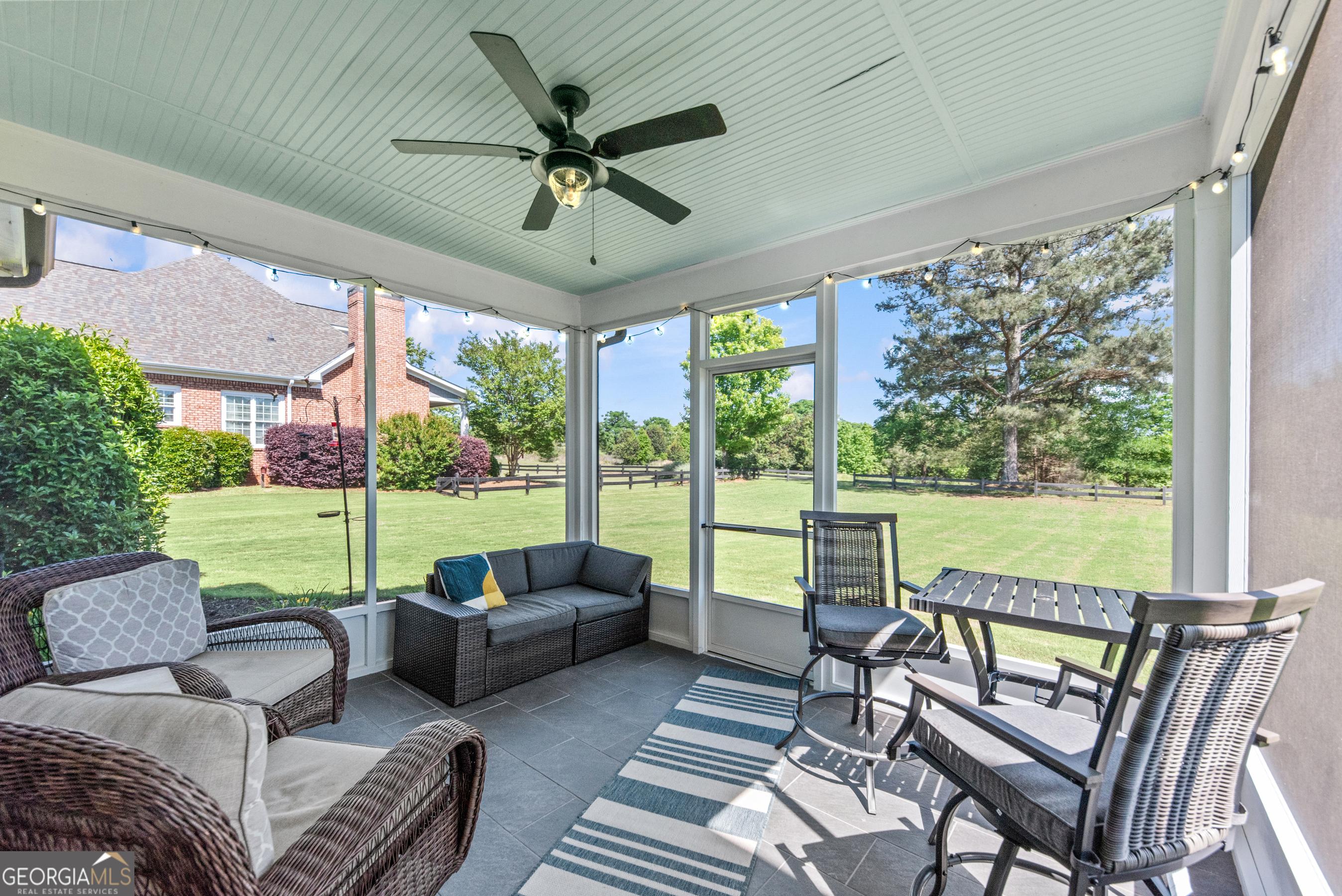 1100 West Magnolia Loop Madison, GA 30650 - Photo 35 of 40 a living room with furniture and a floor to ceiling window