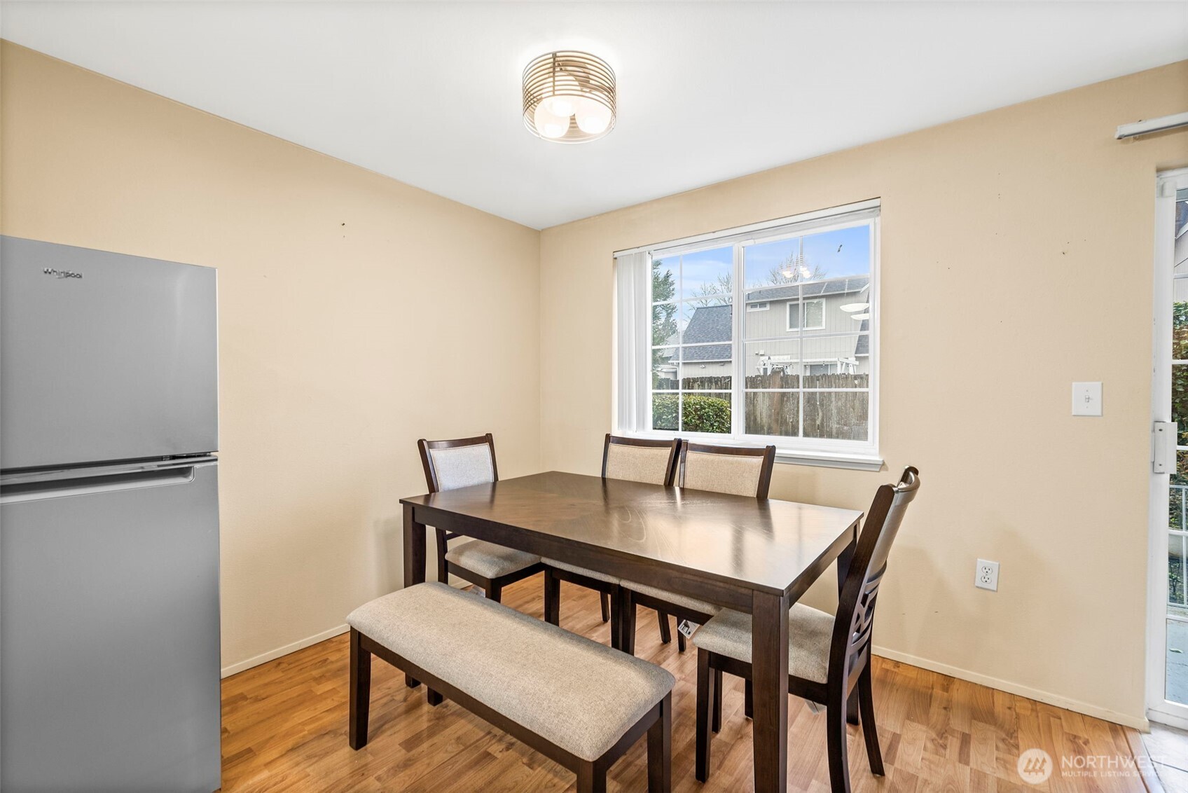 10824 Southeast 170th Street, Unit B103 Renton, WA 98055 - Photo 7 of 31 a view of a dining room with furniture and a window
