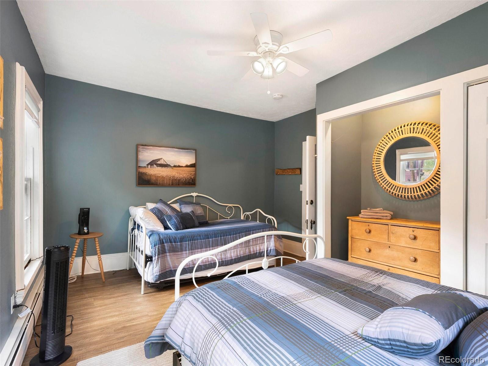 614 Rose Street Georgetown, CO 80444 - Photo 29 of 40 a bedroom with a bed and a chandelier