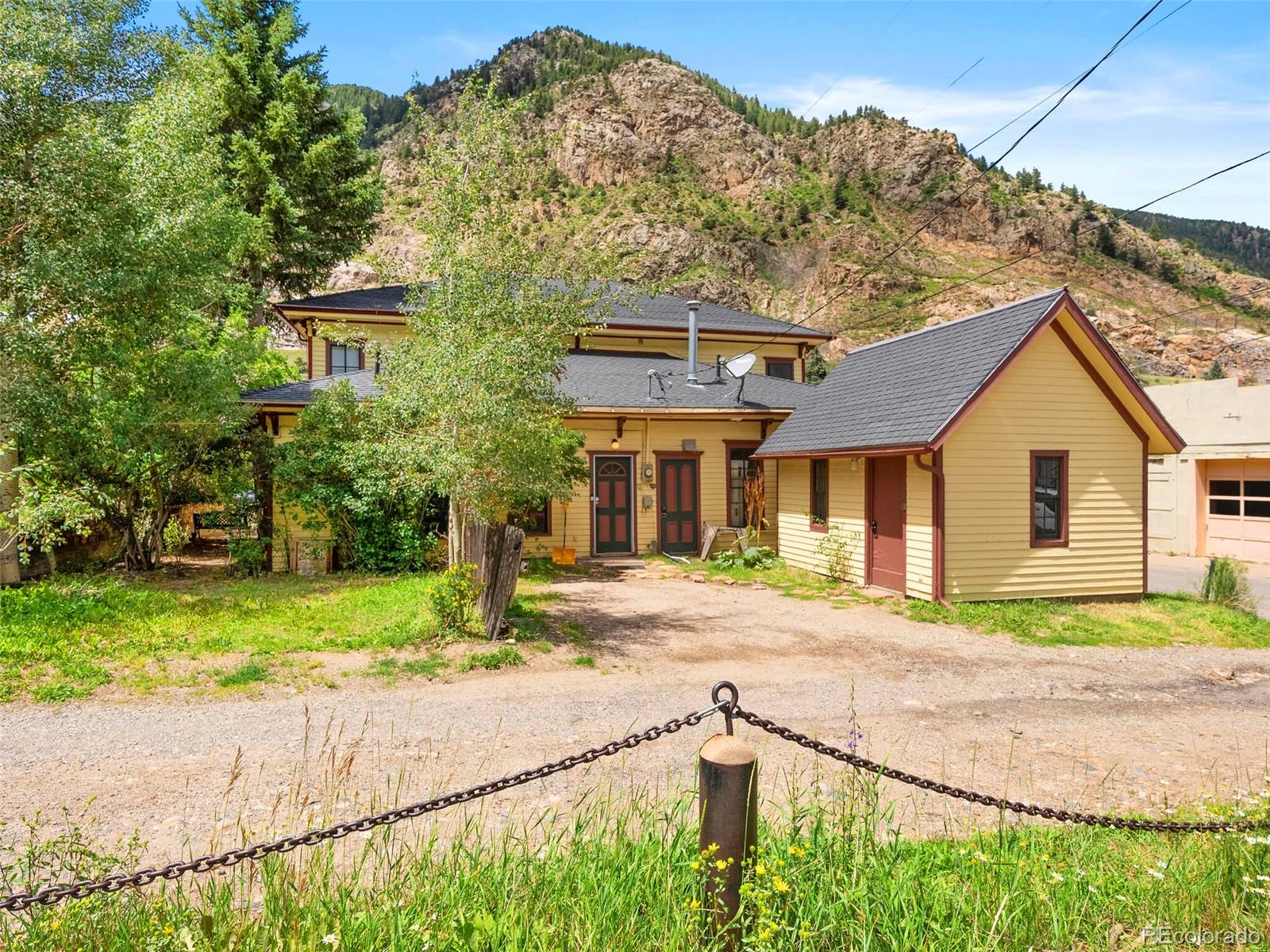 614 Rose Street Georgetown, CO 80444 - Photo 38 of 40 a front view of a house with a yard and garage