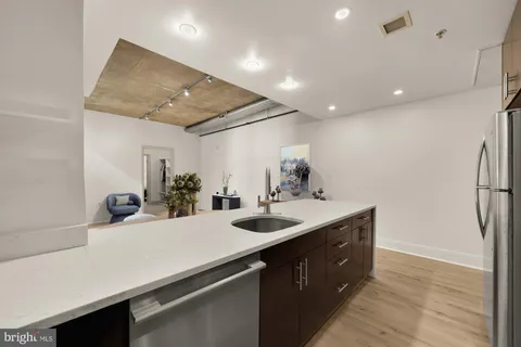 a kitchen with a sink and a refrigerator