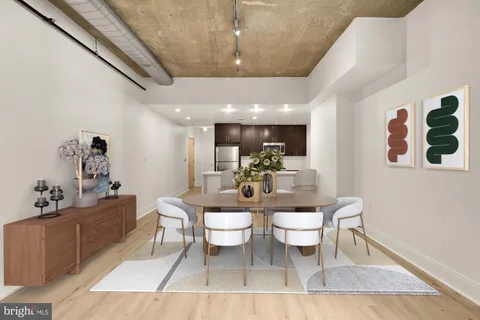 a dining room with furniture and wooden floor