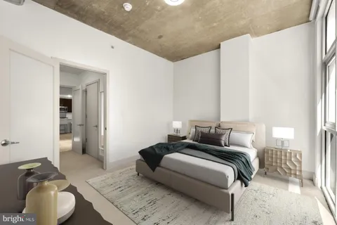 a bedroom with bed and a couch