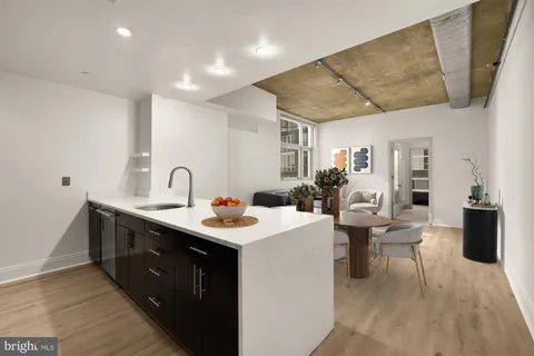 a kitchen with sink cabinets and wooden floor