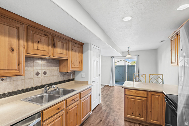 652 West 800 North, Unit 45 Clinton, UT 84015 - Photo 9 of 17 Kitchen featuring wood cabinetry, a double basin stainless steel sink, and a tiled backsplash