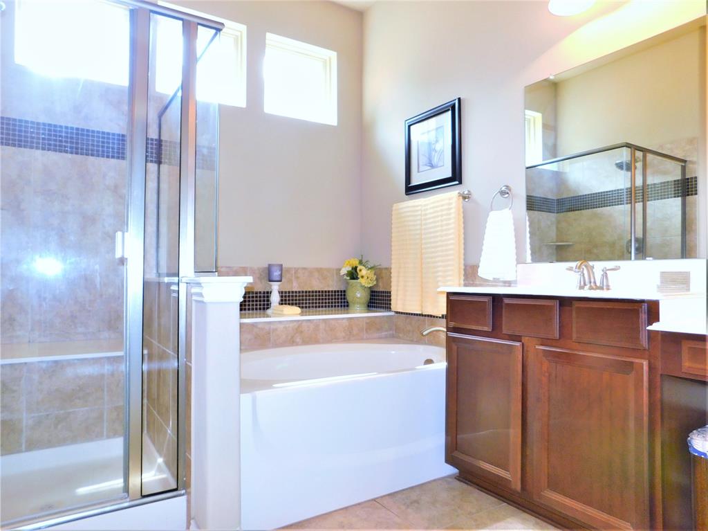 7712 Sweetgate Lane Denton, TX 76208 - Photo 17 of 40 a room with a refrigerator and a mirror