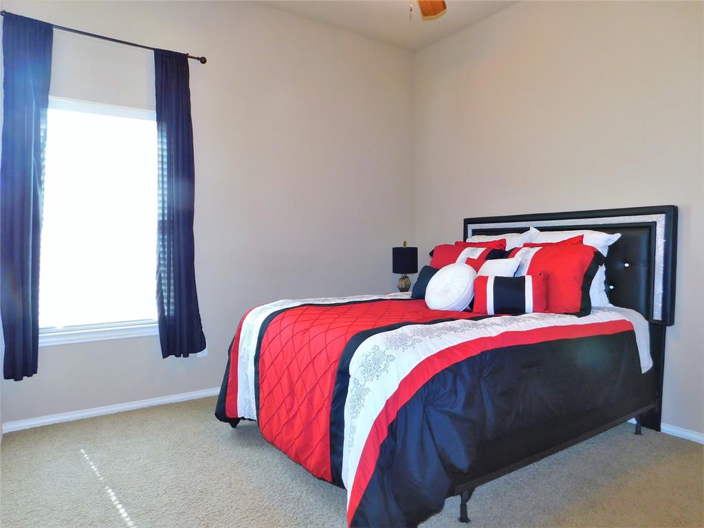 7712 Sweetgate Lane Denton, TX 76208 - Photo 26 of 40 a bedroom with a bed and window