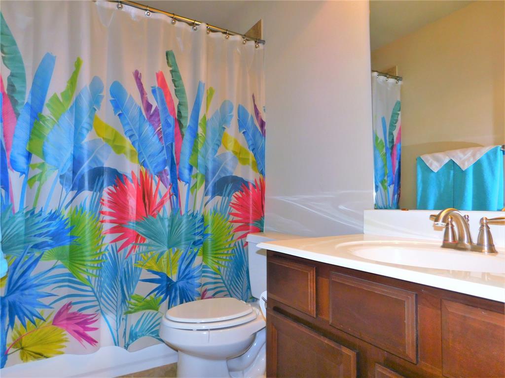 7712 Sweetgate Lane Denton, TX 76208 - Photo 31 of 40 a bathroom with a sink toilet and vanity
