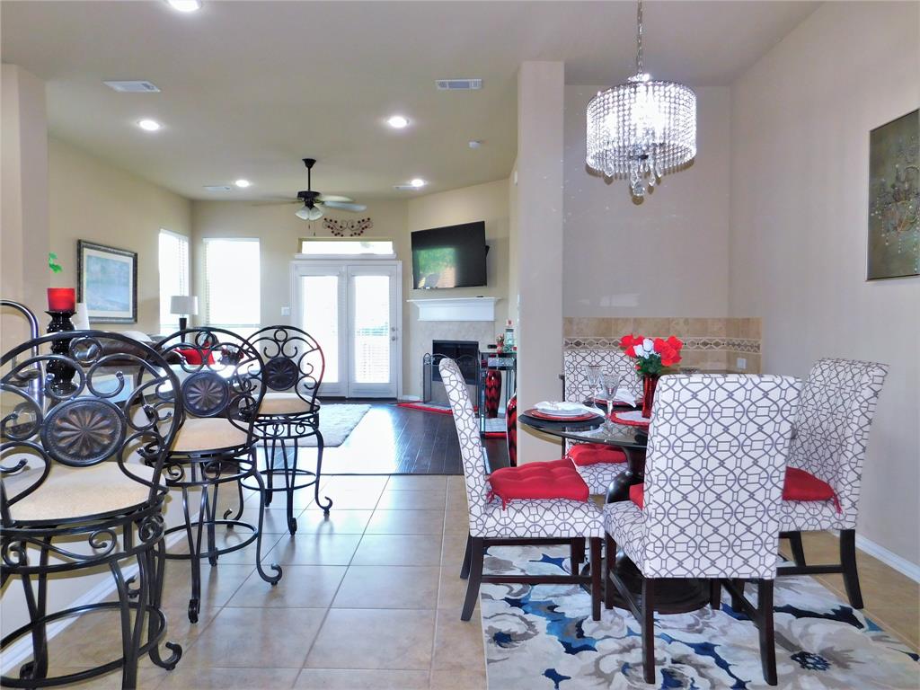 7712 Sweetgate Lane Denton, TX 76208 - Photo 7 of 40 a living room with furniture and a chandelier