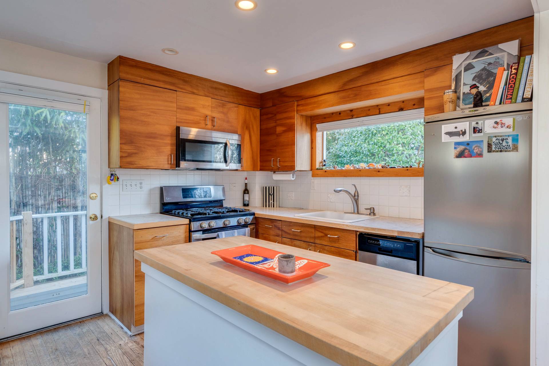 44 Jefferson Street Sag Harbor, NY 11963 - Photo 12 of 18 a kitchen with stainless steel appliances a stove a sink and a refrigerator