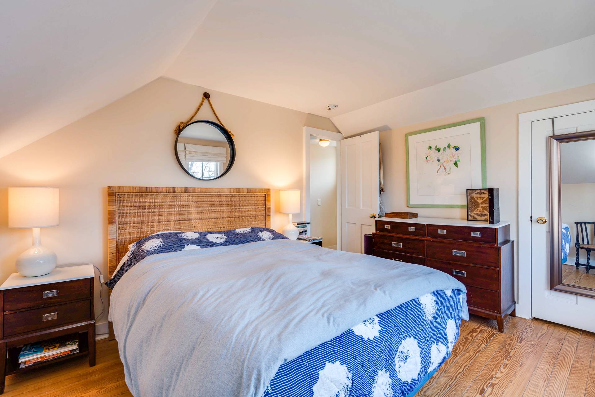 44 Jefferson Street Sag Harbor, NY 11963 - Photo 14 of 18 a bedroom with a bed and a dresser with wooden floor