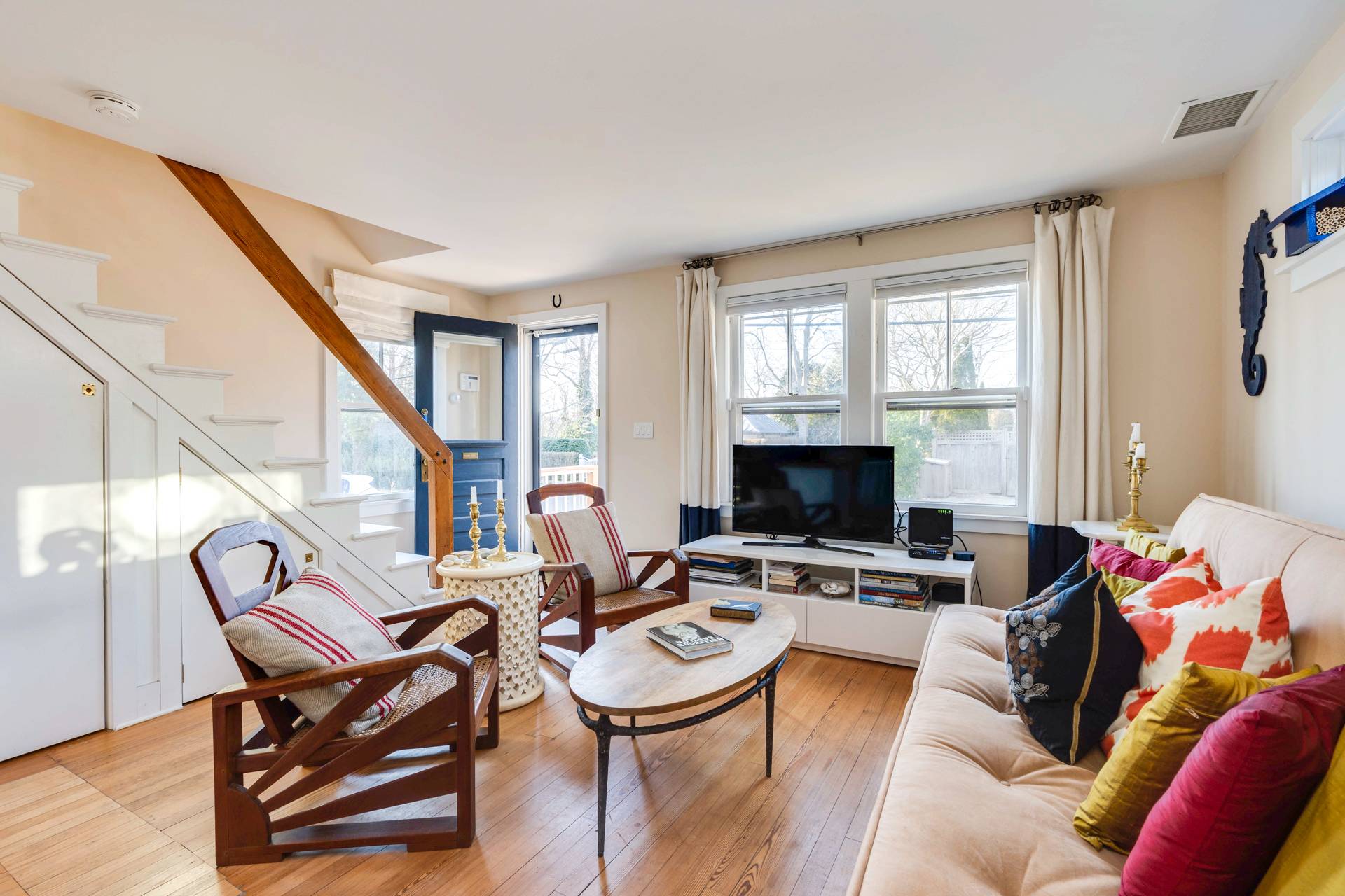 44 Jefferson Street Sag Harbor, NY 11963 - Photo 8 of 18 a living room with furniture a fireplace and a flat screen tv
