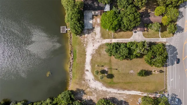an aerial view of a house with a yard