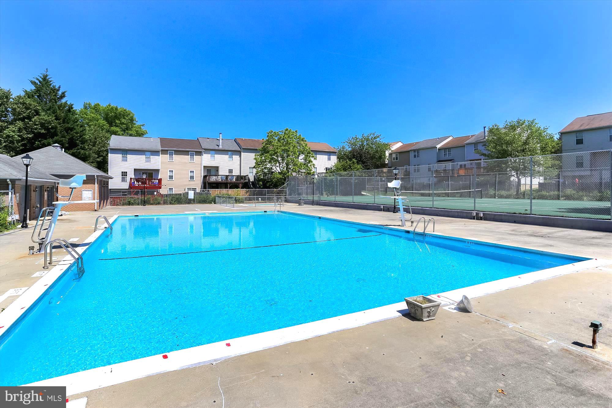 12001 Old Columbia Pike, Unit 514 Silver Spring, MD 20904 - Photo 10 of 41 a view of a swimming pool with a lawn chairs under an umbrella