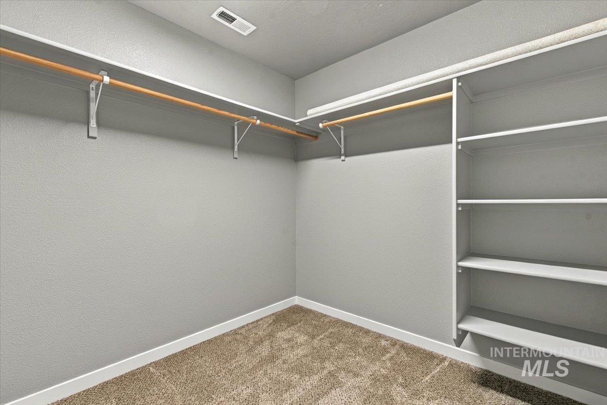 124 South Sunset Point Way Meridian, ID 83642 - Photo 21 of 24 Dedicated laundry area featuring wood-finish flooring and a built-in shelf with a hanging rod