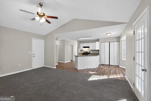 a view of a kitchen with a sink and a refrigerator