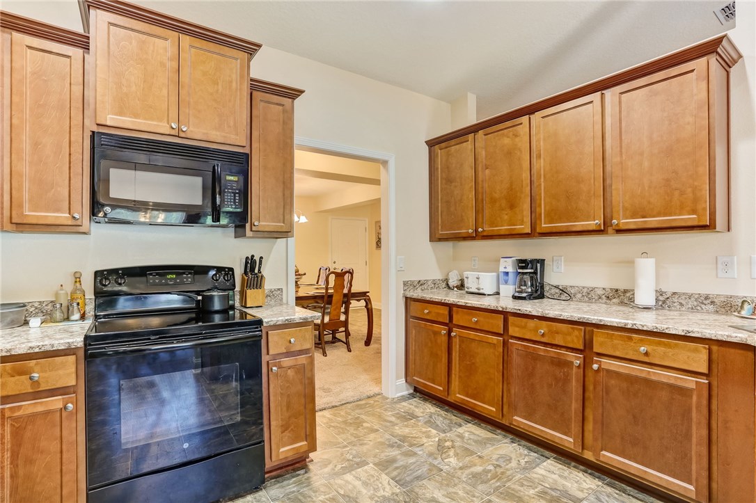 88156 Maybourne Road Yulee, FL 32097 - Photo 11 of 35 a kitchen with granite countertop cabinets stainless steel appliances and a sink