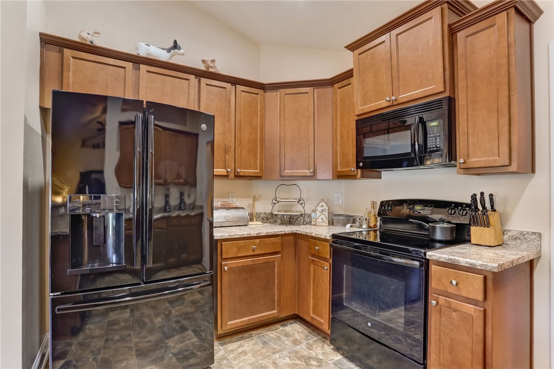 88156 Maybourne Road Yulee, FL 32097 - Photo 13 of 35 a kitchen with stainless steel appliances granite countertop a refrigerator stove and microwave