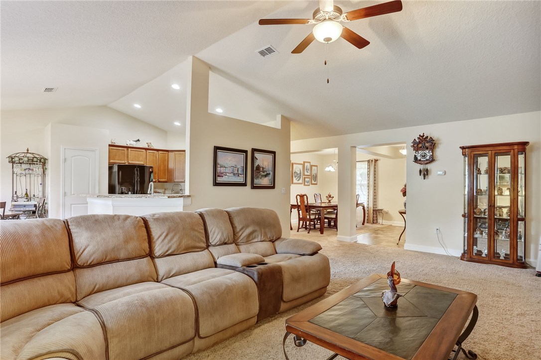 88156 Maybourne Road Yulee, FL 32097 - Photo 18 of 35 a living room with furniture and a chandelier