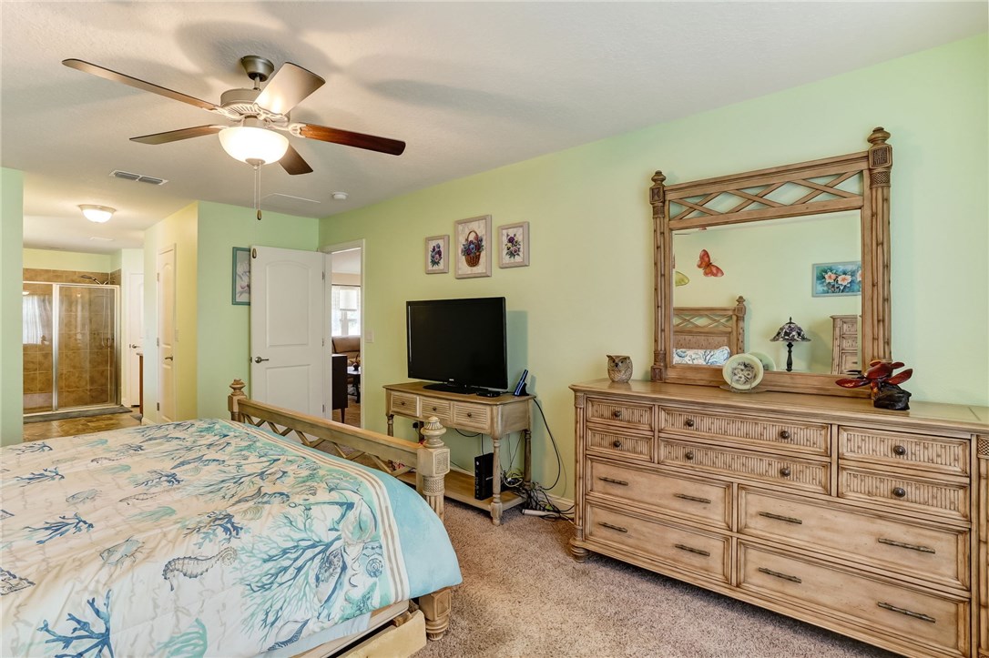 88156 Maybourne Road Yulee, FL 32097 - Photo 20 of 35 a bedroom with a bed and a flat screen tv