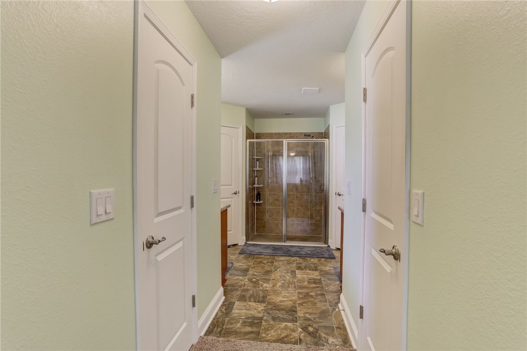 88156 Maybourne Road Yulee, FL 32097 - Photo 21 of 35 a bathroom with a granite countertop shower mirror and a sink