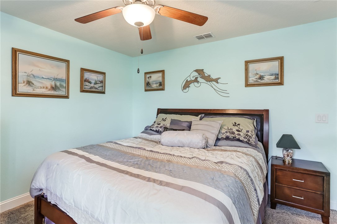 88156 Maybourne Road Yulee, FL 32097 - Photo 25 of 35 a bedroom with a bed and a painting on the wall
