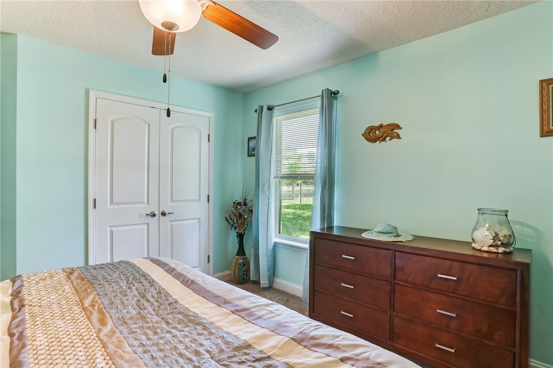 88156 Maybourne Road Yulee, FL 32097 - Photo 26 of 35 a bedroom with a bed and a dresser