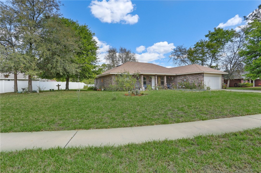 88156 Maybourne Road Yulee, FL 32097 - Photo 3 of 35 a front view of a house with garden