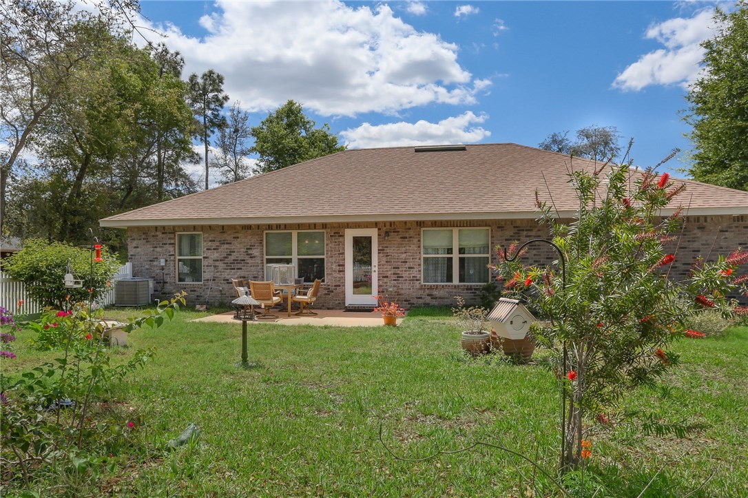 88156 Maybourne Road Yulee, FL 32097 - Photo 31 of 35 a front view of house with backyard and outdoor seating