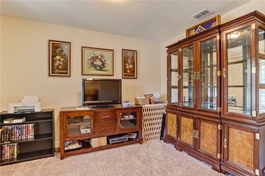 88156 Maybourne Road Yulee, FL 32097 - Photo 6 of 35 a living room with furniture a flat screen tv and a window