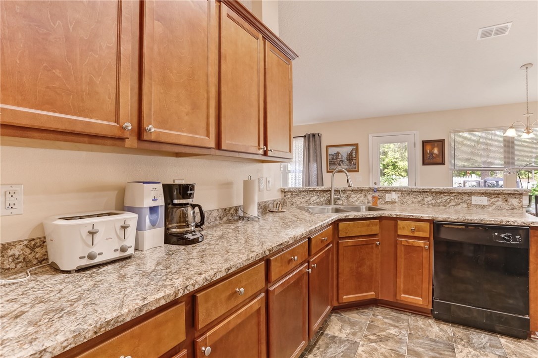 88156 Maybourne Road Yulee, FL 32097 - Photo 10 of 35 a kitchen with granite countertop cabinets sink and stove