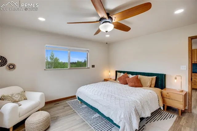 a dining room with furniture and a floor to ceiling window