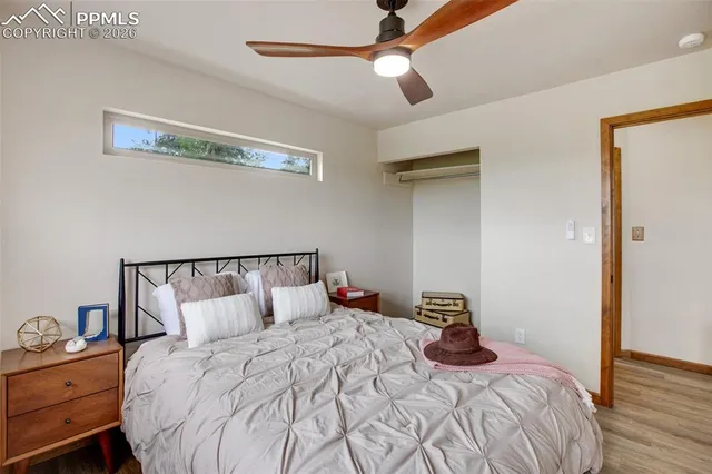a bedroom with a bed and a ceiling fan