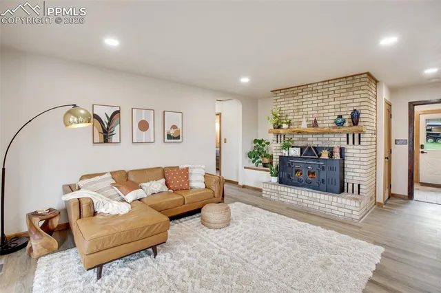 a kitchen with granite countertop wooden cabinets stainless steel appliances and a window