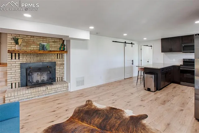 a kitchen with stainless steel appliances kitchen island granite countertop a stove and a sink